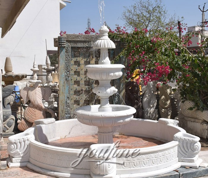 Outside tiered pure marble water fountain with pool in the center of the garden