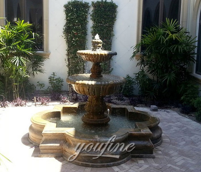 Outdoor antique small marble stone tiered water features in the backyard of the hotel