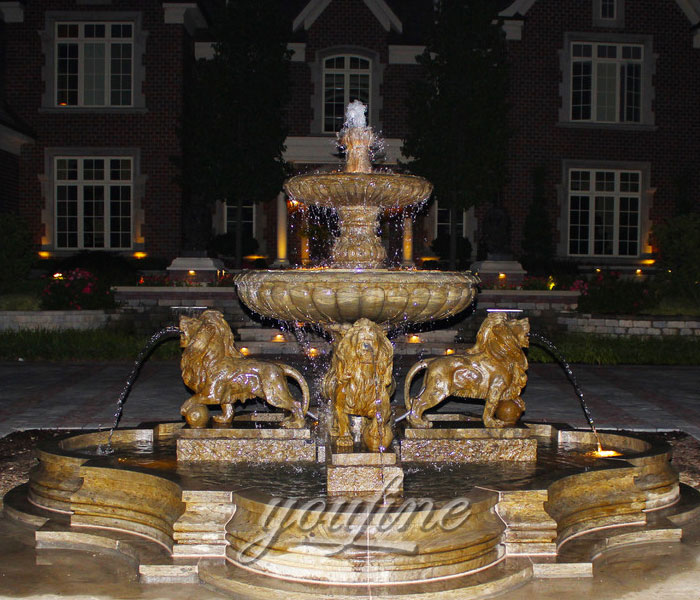 Outdoor antique marble stone tiered water fountain with lion statues in the front of restaurant